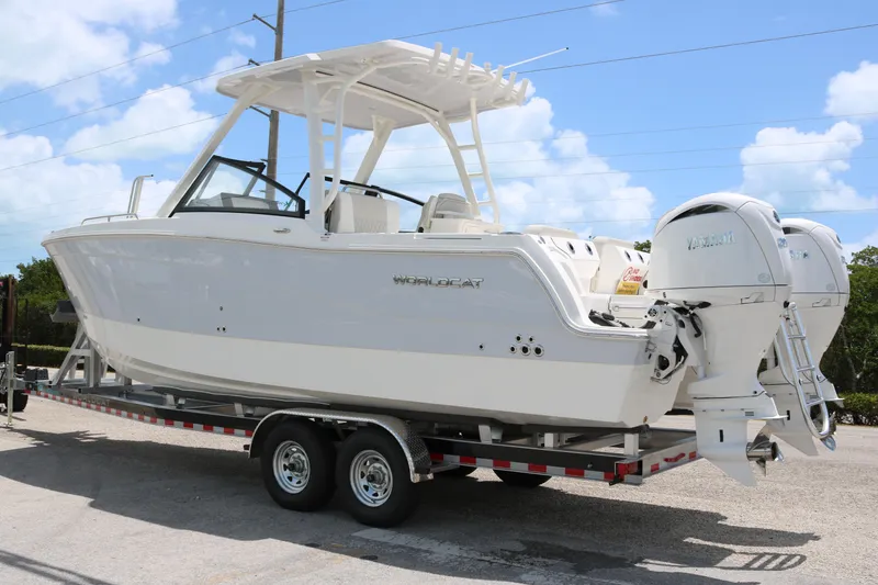Slide: The Image of 2026 World Cat 265 DC-X boat on trailer, featuring dual outboard engines. - 4