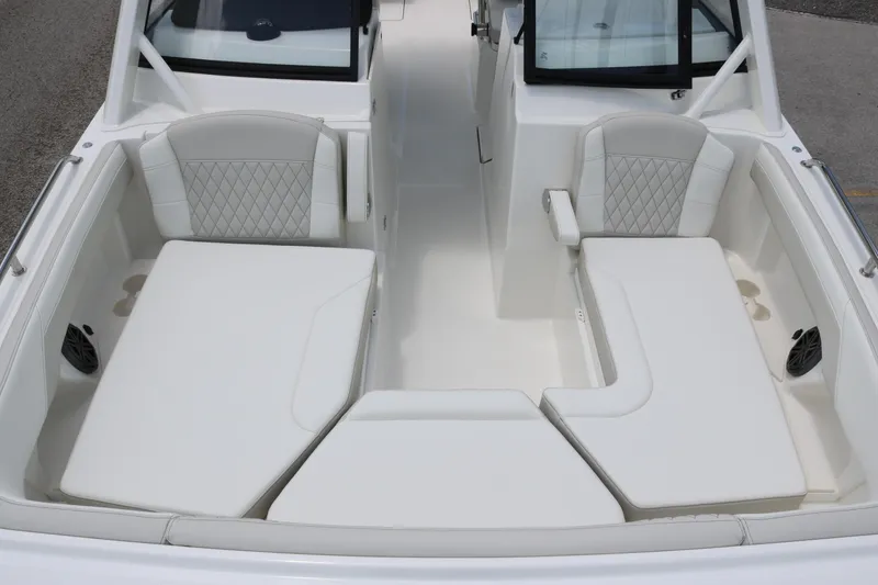 Slide: The Image of 2026 World Cat 265 DC-X boat interior with white cushioned seating and diamond-patterned upholstery. - 7