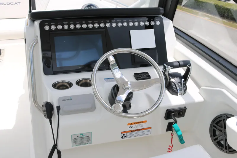 Slide: The Image of Helm of 2026 World Cat 265 DC-X boat with steering wheel and control panel. - 9