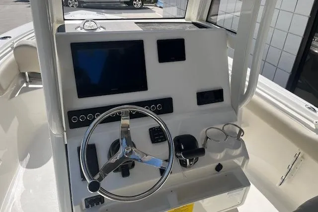 Slide: The Image of 2026 Key West 239 FS boat dashboard with steering wheel and electronic displays. - 11
