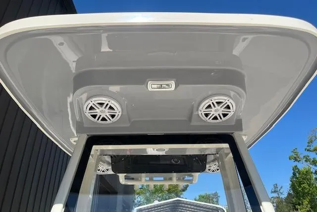 Slide: The Image of 2026 Key West 239 FS boat T-top with speakers and light, under clear blue sky. - 14