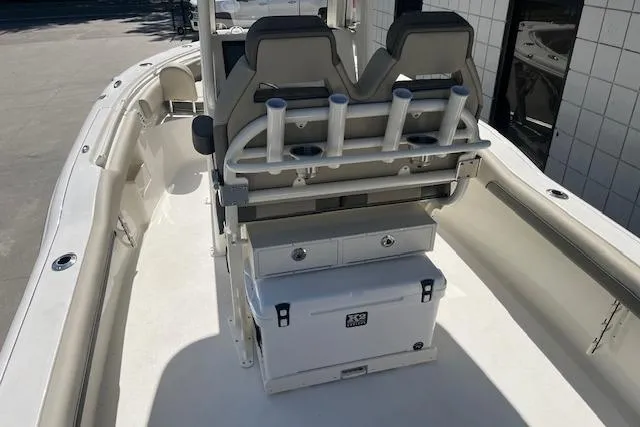 Slide: The Image of 2026 Key West 239 FS boat interior with seating, rod holders, and storage compartments. - 4