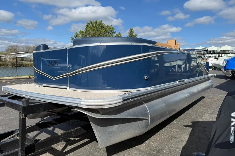 Slide: The Image of 2026 Avalon 2385 25 LSZ QLS pontoon boat on trailer, under blue sky. - 10