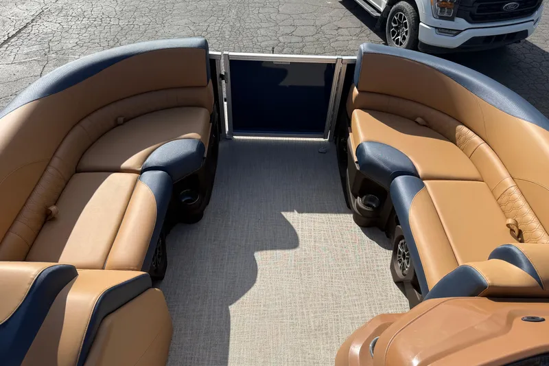 Slide: The Image of Luxurious seating on 2026 Avalon 2385 25 LSZ QLS pontoon boat, featuring tan and navy upholstery. - 11
