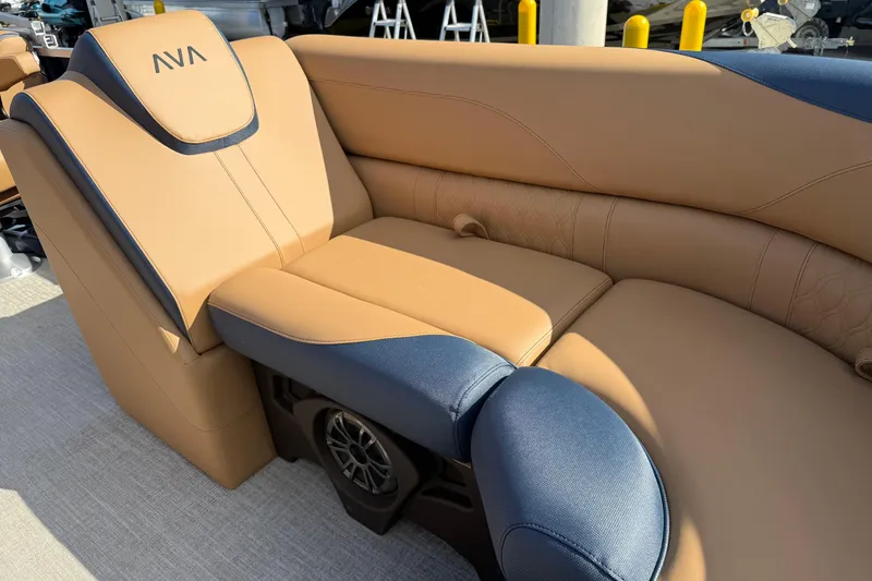 Slide: The Image of Luxurious seating on 2026 Avalon 2385 25 LSZ QLS pontoon boat, featuring tan and navy upholstery. - 12