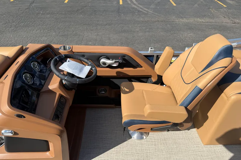 Slide: The Image of 2026 Avalon 2385 25 LSZ QLS boat interior with tan and blue captain's chair and dashboard. - 13