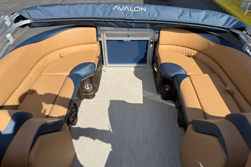 Slide: The Image of Luxurious seating on 2026 Avalon 2385 25 LSZ QLS pontoon boat, featuring tan and navy upholstery. - 15
