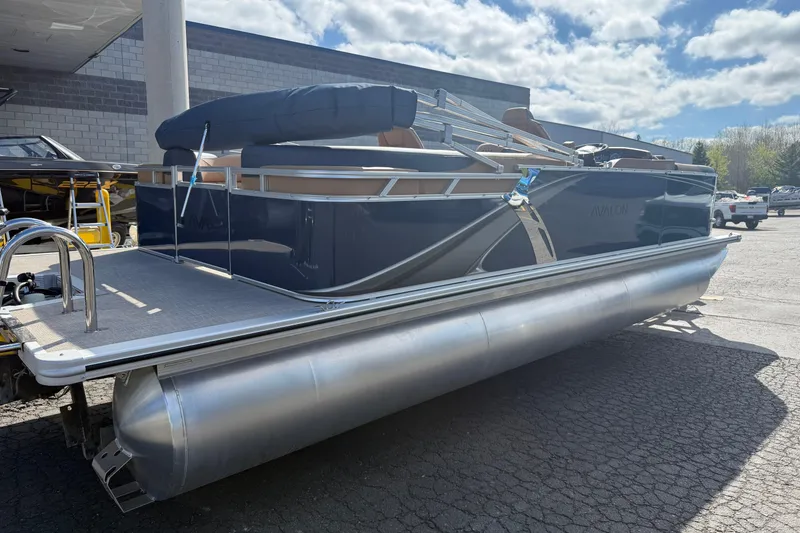 The Image of 2026 Avalon 2385 25 LSZ QLS pontoon boat parked outdoors under a cloudy sky. - 9