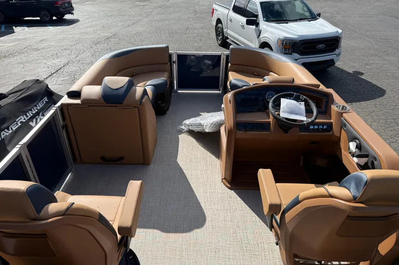 Slide: The Image of 2026 Avalon 2385 25 LSZ QLS pontoon boat interior with tan seating and steering console. - 17