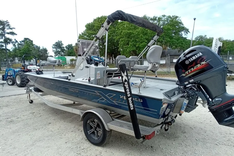 Slide: The Image of 2021 Xpress H20B Bay boat with Yamaha outboard motor on trailer. - 10