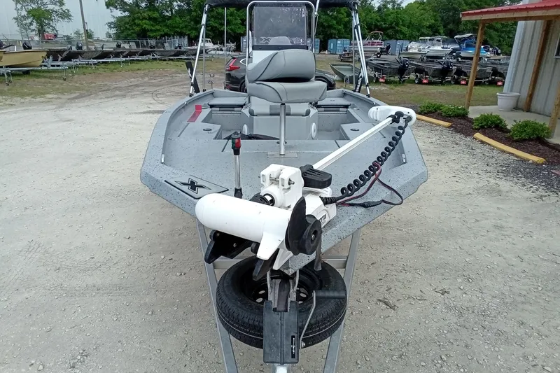 Slide: The Image of 2021 Xpress H20B Bay boat with trolling motor in outdoor setting. - 4