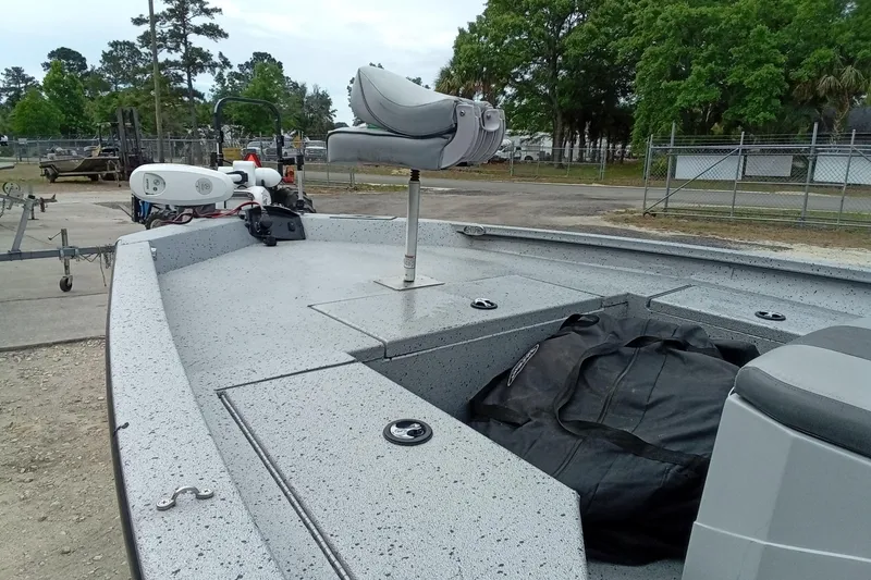 Slide: The Image of 2021 Xpress H20B Bay boat with seating and storage, parked outdoors. - 7