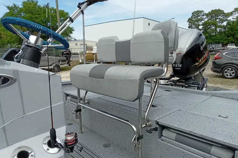 Slide: The Image of 2021 Xpress H20B Bay boat interior with seating and Yamaha outboard motor. - 8