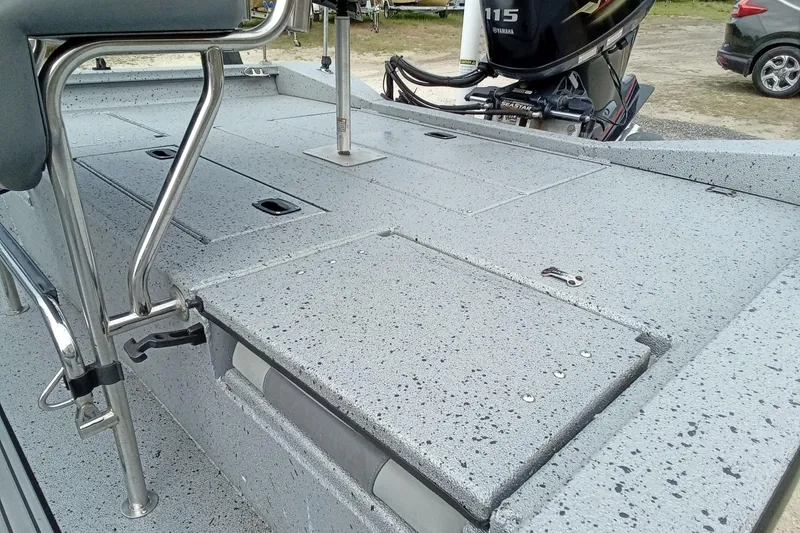 Slide: The Image of 2021 Xpress H20B Bay boat deck with Yamaha 115 engine, featuring speckled non-slip surface. - 9