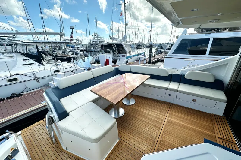 Slide: The Image of Luxurious 2015 Azimut 55S yacht with elegant outdoor seating and wooden deck at marina. - 10