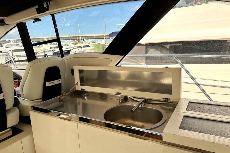Slide: The Image of Interior view of 2015 Azimut 55S yacht featuring a sleek kitchen sink area. - 24