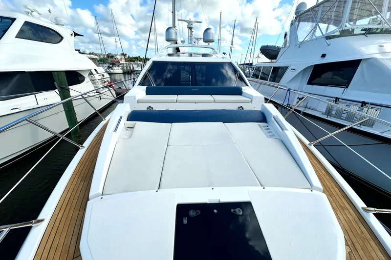 Slide: The Image of 2015 Azimut 55S yacht with spacious deck, docked at marina under blue sky. - 4