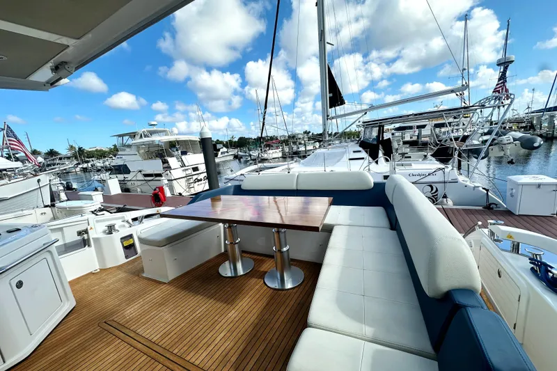 Slide: The Image of Luxurious 2015 Azimut 55S yacht deck with seating and table, docked at marina. - 8