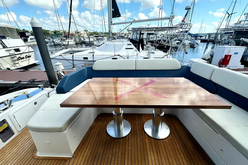 Slide: The Image of Azimut 55S 2015 yacht deck with wooden table and marina view. - 9