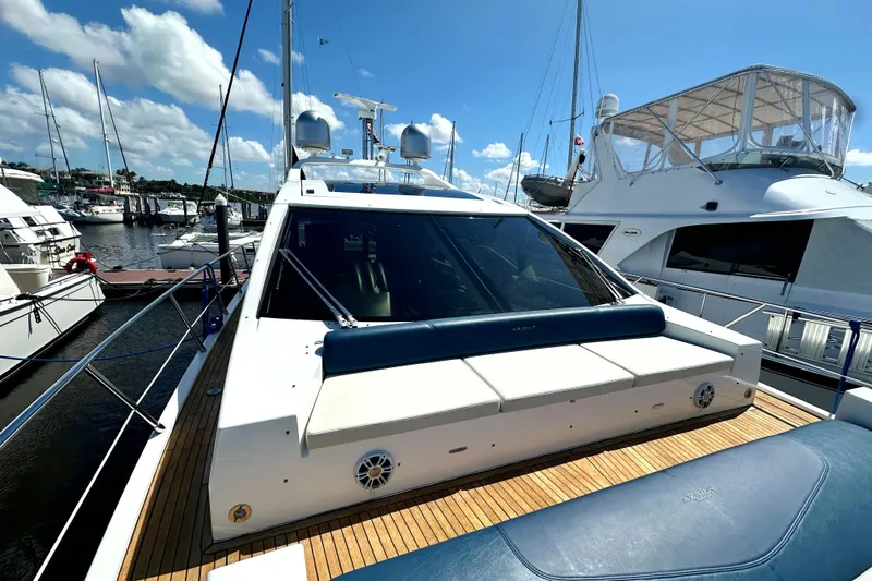 Slide: The Image of 2015 Azimut 55S yacht docked at marina, featuring sleek design and spacious deck. - 6