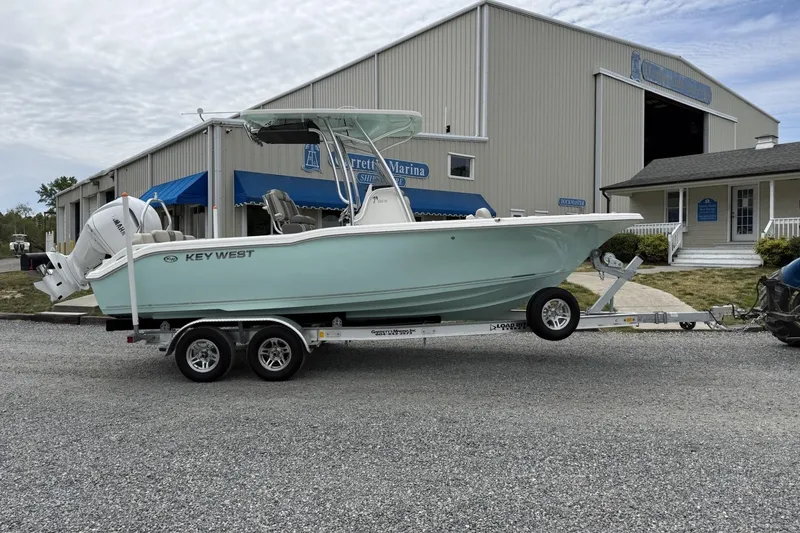 The Image of 2026 Key West 239 FS boat on trailer outside marina building. - 0