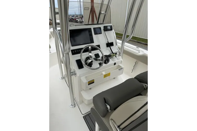 Slide: The Image of 2026 Key West 239 FS boat console with steering wheel and navigation equipment. - 2