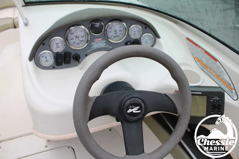 Slide: The Image of Dashboard of a 2005 Sea Ray 180SPBR boat with steering wheel and gauges. - 10