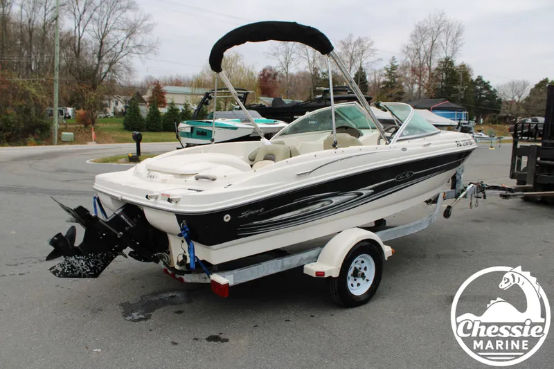 Slide: The Image of 2005 Sea Ray 180SPBR boat on trailer, Chessie Marine logo. - 3