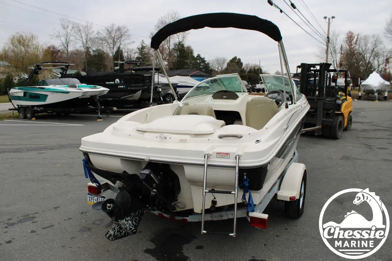 Slide: The Image of 2005 Sea Ray 180SPBR boat in a parking lot. - 8