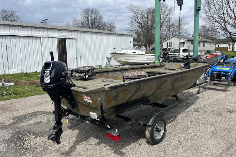 Slide: The Image of 2022 Alumacraft 1650 All Weld MV Tiller boat on trailer, parked outdoors. - 4