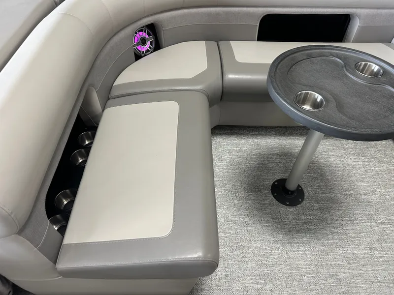 Slide: The Image of Interior of 2024 Premier 230 Sunsation TRITOON with gray seating and table. - 27