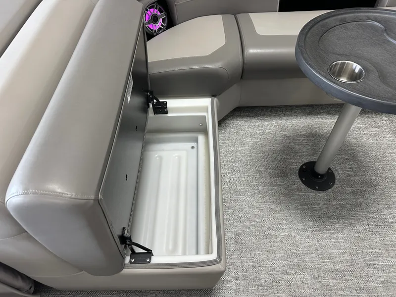 Slide: The Image of Interior of 2024 Premier 230 Sunsation TRITOON with storage and table. - 28