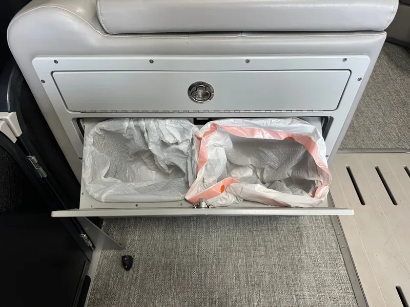 Slide: The Image of Premier 230 Sunsation TRITOON 2024 trash compartment with two bags. - 41