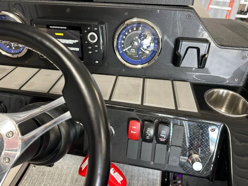 Slide: The Image of Dashboard of 2024 Premier 230 Sunsation TRITOON with controls and gauges. - 46