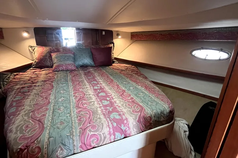 Slide: The Image of Cozy cabin interior of 1999 Tiara Yachts 3500 Open with patterned bedding. - 13