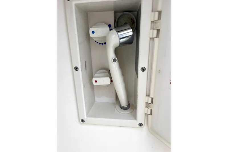 Slide: The Image of 1999 Tiara Yachts 3500 Open shower compartment with faucet and handheld showerhead. - 35