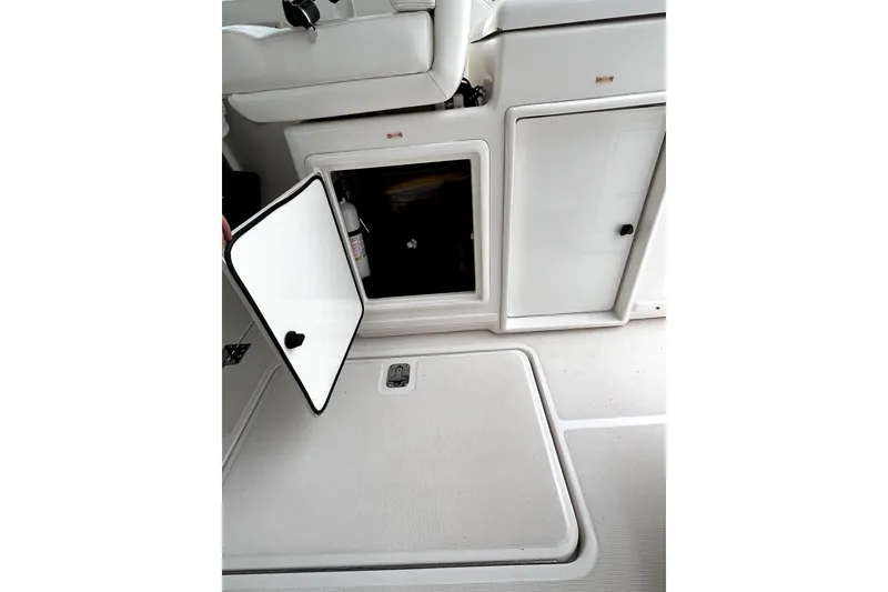 Slide: The Image of 1999 Tiara Yachts 3500 Open interior storage compartment with open door, showcasing sleek design. - 24