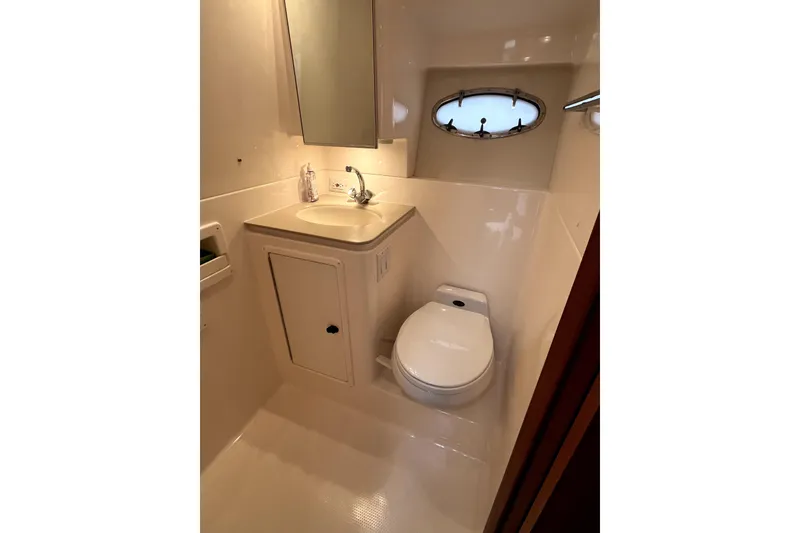 Slide: The Image of Bathroom interior of 1999 Tiara Yachts 3500 Open with sink and toilet. - 15