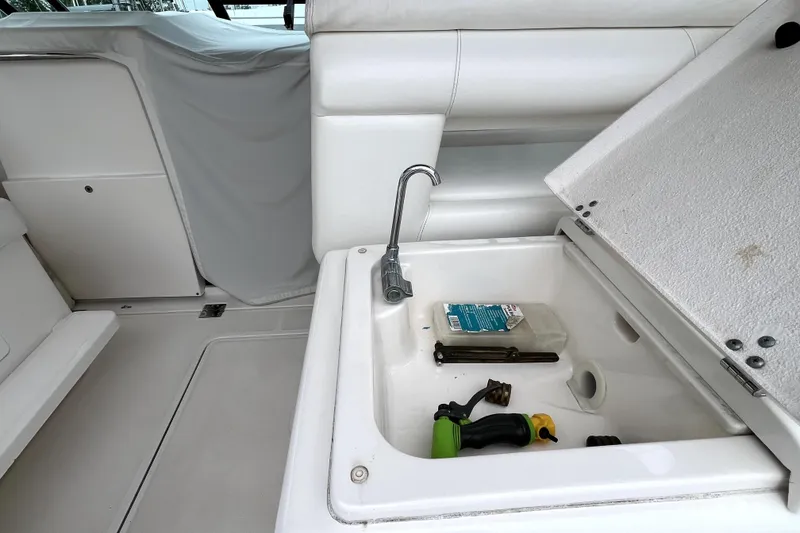 Slide: The Image of 1999 Tiara Yachts 3500 Open interior with storage compartment and tools. - 22