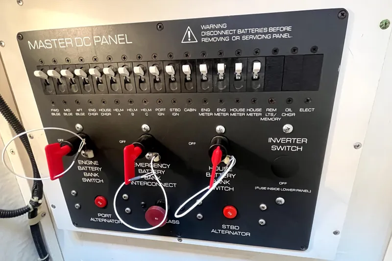 Slide: The Image of Master DC panel of a 1999 Tiara Yachts 3500 Open, featuring switches and controls. - 47