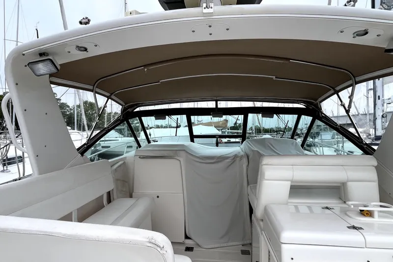 Slide: The Image of 1999 Tiara Yachts 3500 Open interior with covered seating and helm, docked at marina. - 19