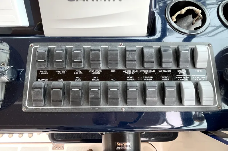 Slide: The Image of Control panel of a 1999 Tiara Yachts 3500 Open with labeled switches. - 28