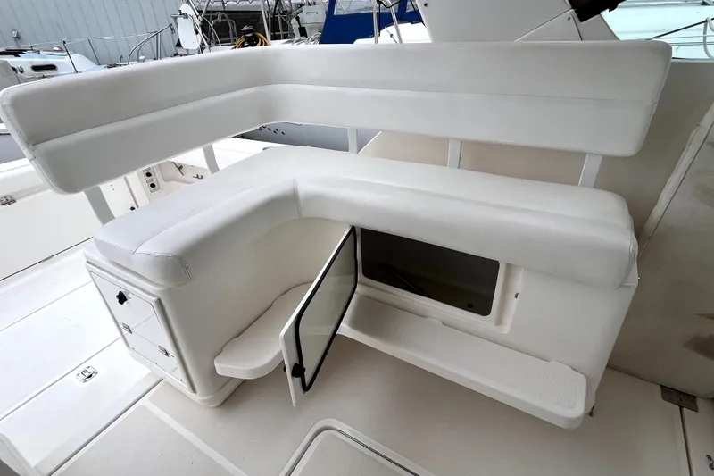 Slide: The Image of 1999 Tiara Yachts 3500 Open boat seating area with storage compartment open. - 20