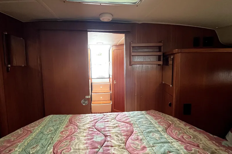 Slide: The Image of Interior cabin of a 1999 Tiara Yachts 3500 Open with wood paneling and bed. - 14