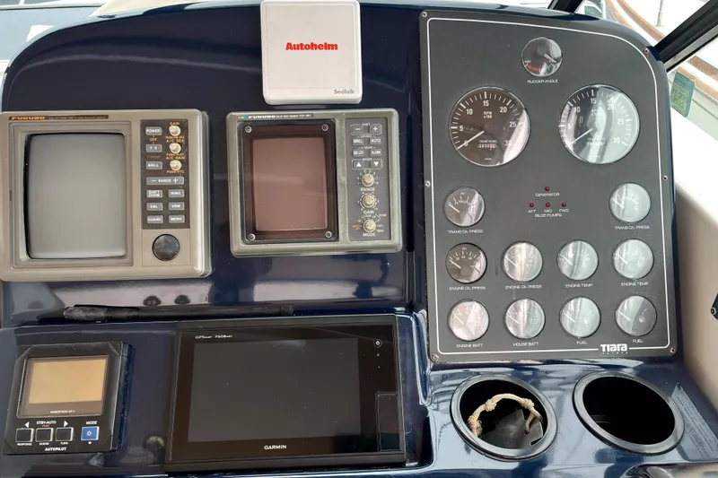 Slide: The Image of Control panel of a 1999 Tiara Yachts 3500 Open with navigation and engine gauges. - 27