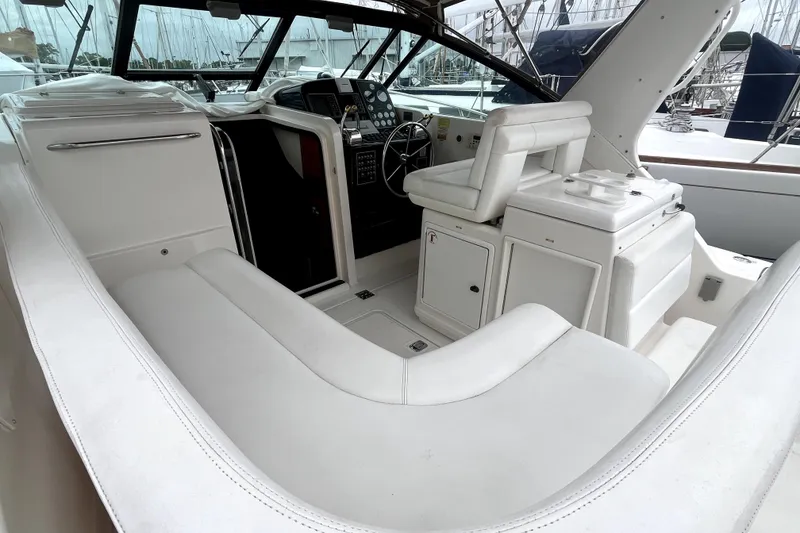 Slide: The Image of 1999 Tiara Yachts 3500 Open cockpit with white seating and helm station. - 18