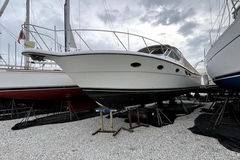 Slide: The Image of 1999 Tiara Yachts 3500 Open boat on stands, cloudy sky background. - 4