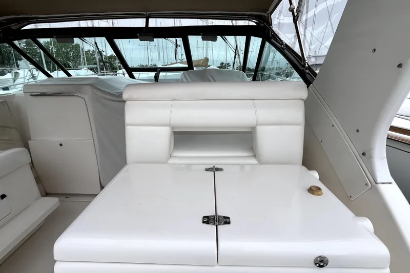 Slide: The Image of 1999 Tiara Yachts 3500 Open interior with white seating and covered helm. - 21