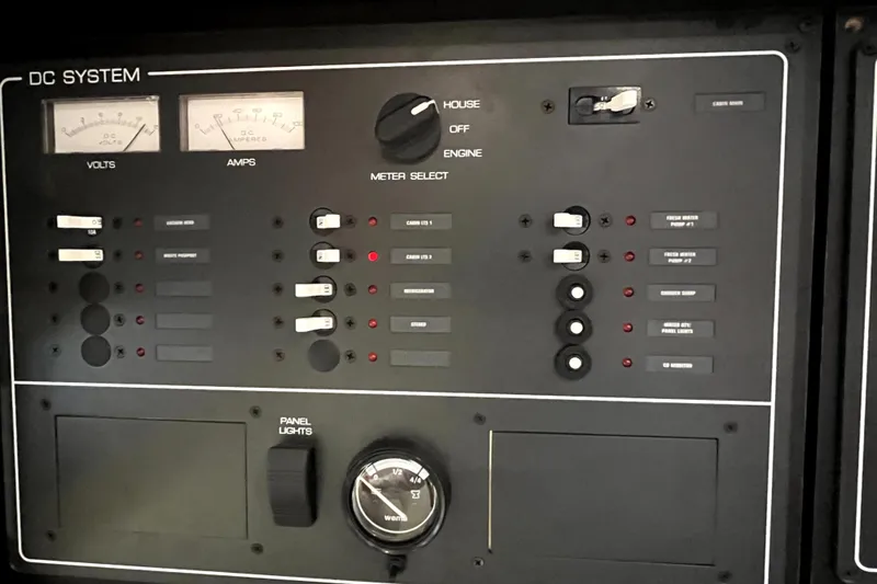 Slide: The Image of Control panel of a 1999 Tiara Yachts 3500 Open, featuring volt and amp meters. - 46