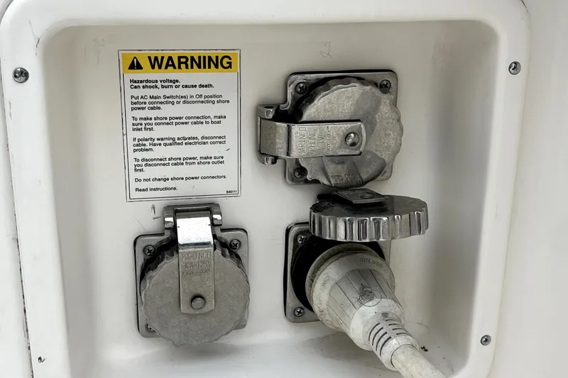Slide: The Image of Electrical connections and warning label on a 1999 Tiara Yachts 3500 Open. - 34